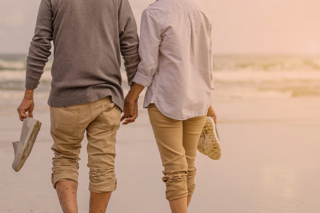 two people holding hands on the beach